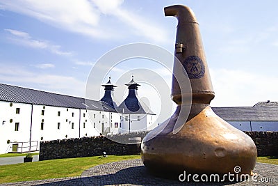 Old copper still at the entrance of the Ardbeg whisky distillery on the isle of Islay Editorial Stock Photo