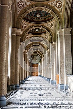 An old corridor with a beautiful floor and painted ceilings Stock Photo