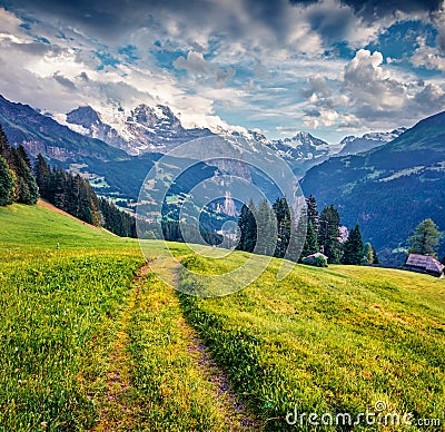 Old country road on the mountain valley. Dramatic summer view of Wengen village. Nice morning scene of countryside in Swiss Alps, Stock Photo