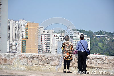 An old couple enjoy the beauty of Macau cityscape Editorial Stock Photo