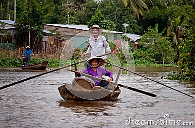 Old couple rowing on the river Mekong Editorial Stock Photo