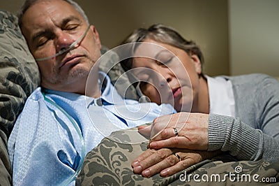 Old couple sleeping together man nasal cannula Stock Photo