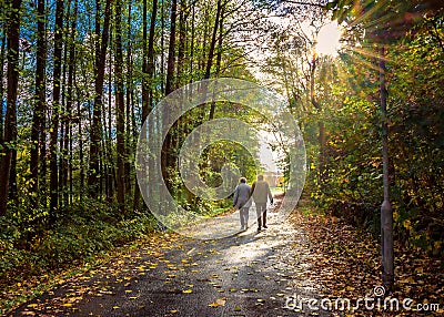 Old couple walking hand in hand Stock Photo