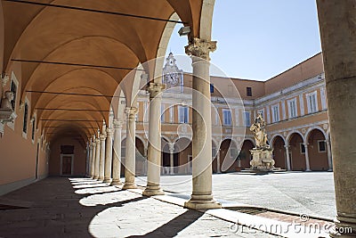 Old courtyard with vaults and a statue, in Pisa, Italy. Stock Photo