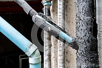 Old crack insulation foam wrapping PVC pipe Stock Photo