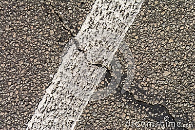 The old cracked asphalt road. White markings on the road. Repair is required. Copy space. Stock Photo