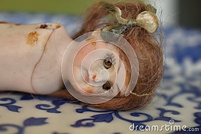Old and cracked porcelain doll Stock Photo
