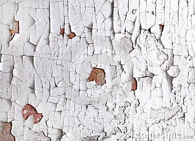 Old cracked white paint peeling off from wall texture background. Close-up detail of cracked paint Stock Photo