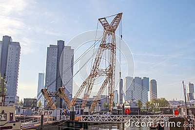 Old crane in harbor named Leuvehaven in downtwon Rotterdam on sunny day Editorial Stock Photo
