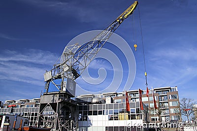 Old crane in harbor named Leuvehaven in downtwon Rotterdam on sunny day Editorial Stock Photo