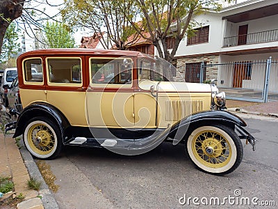 Old cream 1930s Ford Model A Fordor sedan three window parked in Editorial Stock Photo