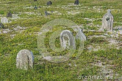 Old creepy burial ground with graves at the tropical local island Maamigili Stock Photo