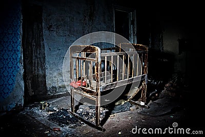 Old creepy eerie wooden baby crib in abandoned house. Horror concept Stock Photo