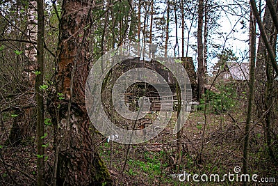 An old, crumbling abandoned house in the woods.an ancient, century-old house, living out its last years Stock Photo
