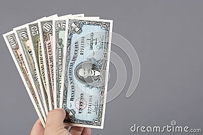 Old Cuban money in the hand on a gray background Stock Photo