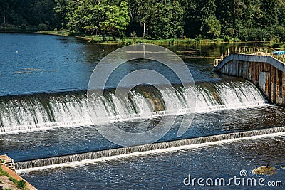 Old dam at ancient hydroelectric power station, water flows Stock Photo