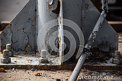 Old damaged cables on the background of a rust metal structure with bolts Stock Photo
