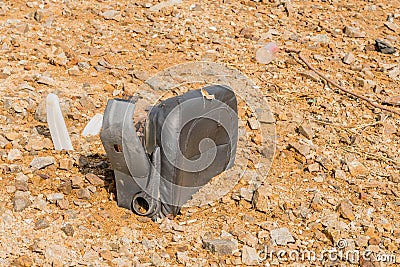 Old, damaged, discarded office chair buried under mud Stock Photo