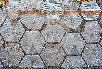 Old damaged hexagonal stone block pavement Stock Photo