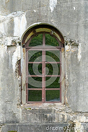 Old damaged plastered brick wall with window Stock Photo