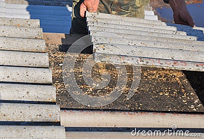 Old and danger asbestos removal. Roofers replace damaged asbestos tile. Repair asbestos roof Stock Photo