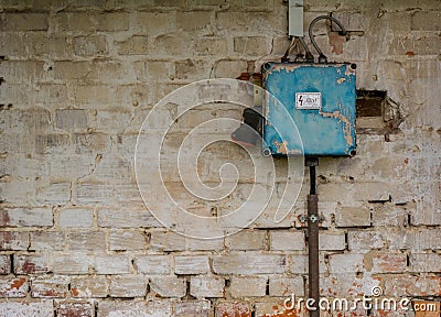 Old bad rusty switch box on weathered wall Stock Photo