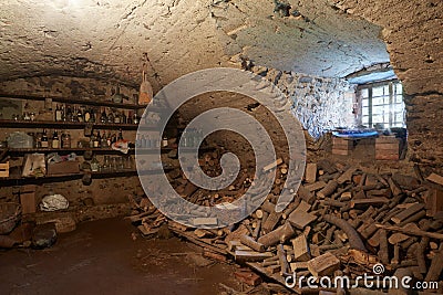 Old, dark basement with wood pile interior Stock Photo
