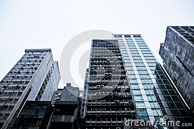 Old dark grey high-rises office and residential buildings in Hong Kong Stock Photo