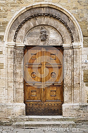 Old decorated wooden door of a church in Bevagna in Umbria Italy. Stock Photo