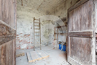 Old depository room with wooden portal in old country house Stock Photo