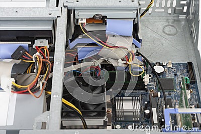 Old desktop computer, inside floppy disk drive, CD drive, hard disk drive, main board , power supply unit. PC without upper board Stock Photo