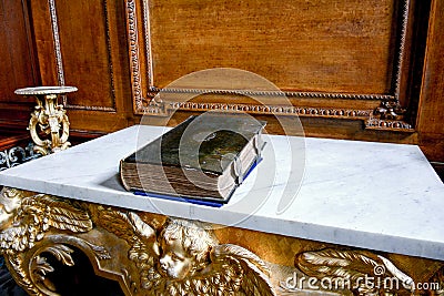 Old destroyed leather bound Bible lying on the altar Stock Photo