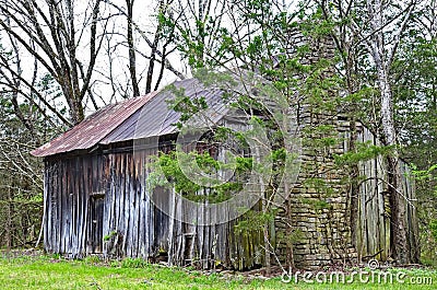 A primitive abandoned house with stone rock fireplace Stock Photo