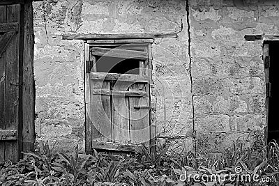 old dilapidated wooden door in a brick building Stock Photo