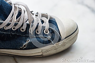 Old dirty blue sneaker. Teenager fashion Stock Photo