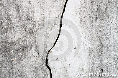 Old dirty cement wall broken apart left a long crack on the wall Stock Photo