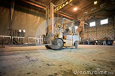Old dirty forklift machine in the warehouse Editorial Stock Photo