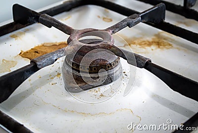 Dirty rusty switch off gas stove burner. Stock Photo