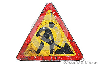 Old dirty rusty triangular road sign `Under construction`. Stock Photo