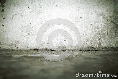 Old dirty wall with cracks at the junction with the floor, textured background Stock Photo