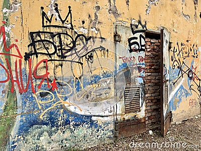 Old dirty wall spray painted and tagged Editorial Stock Photo