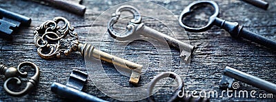 Old door keys lying on the table. Choose the right key. Concept on the topic of security, choice, search, etc. Retro style Stock Photo