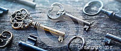 Old door keys lying on the table. Choose the right key. Concept on the topic of security, choice, search, etc. Retro style Stock Photo