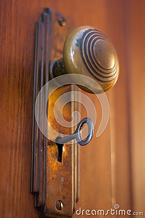 Old Door knob with key Stock Photo