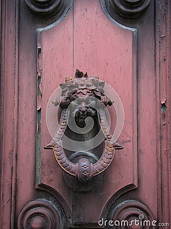 Old doorknocker on pink door Stock Photo