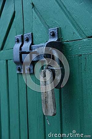 Old doors gates closed with black metall padlock with hasp Stock Photo