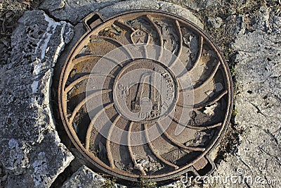 Old drainage, cast iron manhole, Soviet-made Stock Photo