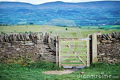 Old dry stone wall in welsh countryside, mountains in background Stock Photo