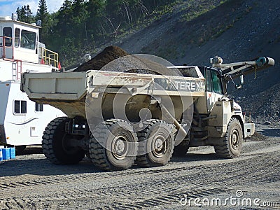 An old dumptruck at a rustic stone-crushing quarry in the yukon Editorial Stock Photo