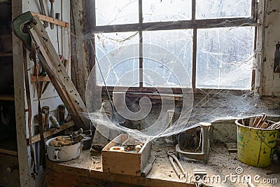Old dusty DIY workshop abandoned with cobwebs, as if frozen in time. Stock Photo